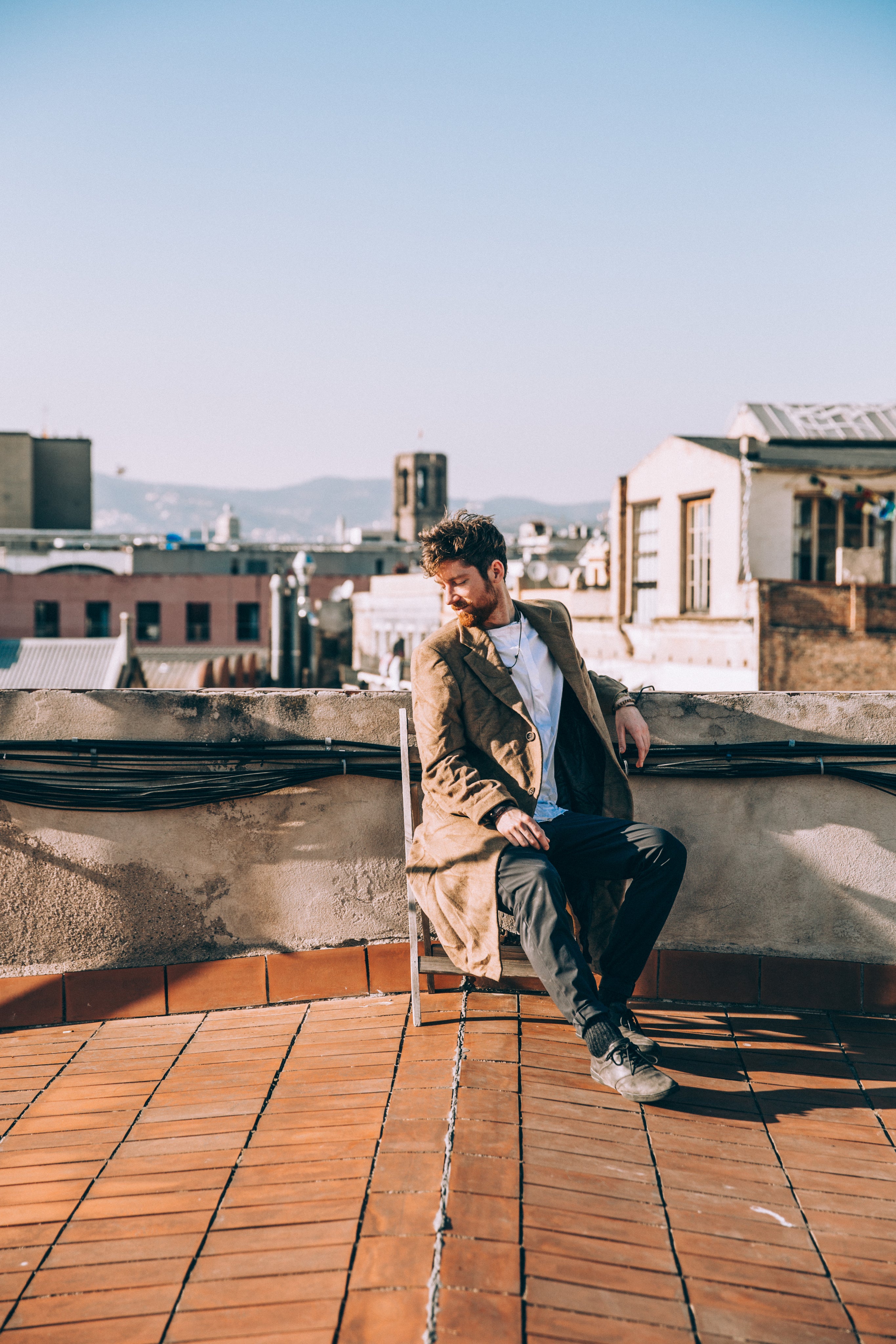 files/man-sits-on-chair-on-rooftop.jpg